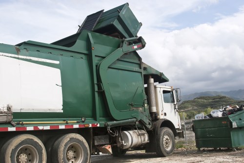 Business staff placing cardboard into commercial recycling bay
