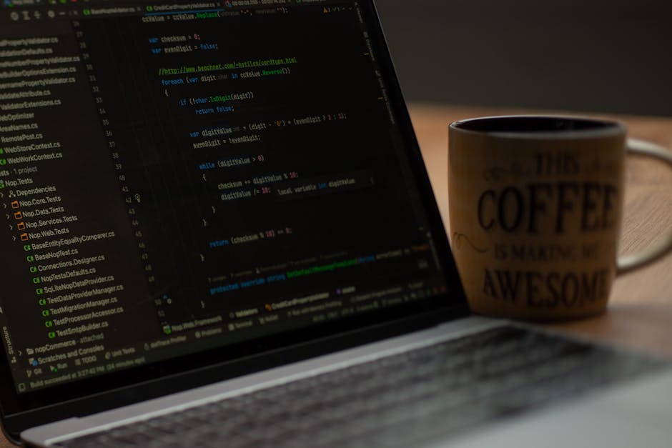 The image depicts a close-up view of a computer screen displaying lines of HTML and CSS code with syntax highlighting in various colors, including yellow, red, blue, and green. The code is organized i